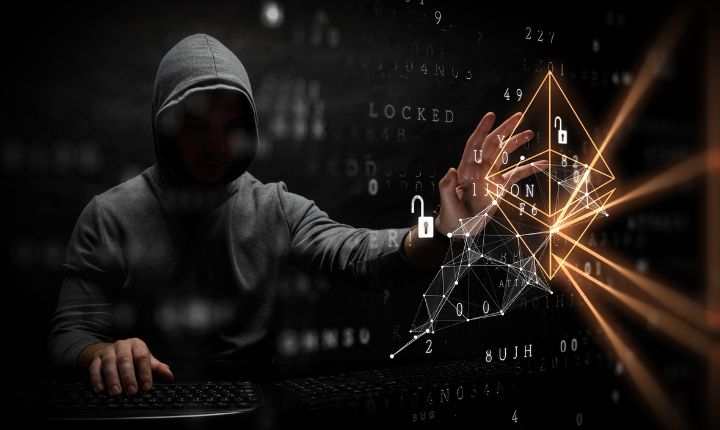 Una figura encapuchada llevando a cabo fraudes en eCommerce. Lo vemos interactuar con un holograma que representa la invasión de privacidad y robo de datos.