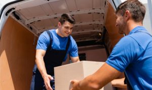 Repartidores de iMile bajando cajas de una furgoneta logística.