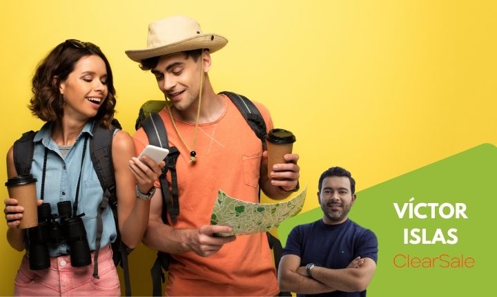 en un fondo amarillo dos viajeros, hombre y mujer deteniendo vasos de café se acercan a ver un mapa y su móvil, representando las Tendencias de turismo en México 2023